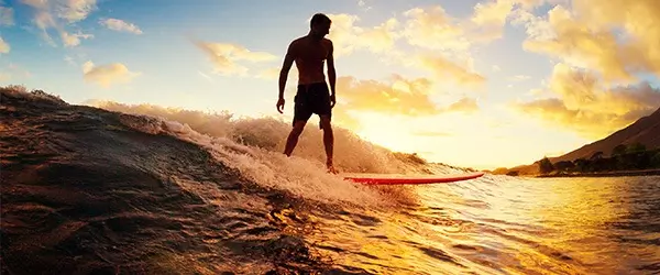 sihoulette of man surfing